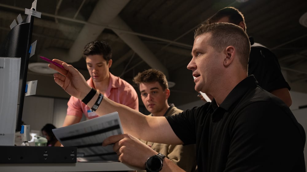 Airmen and industry partners test software during the Air Force’s third Advanced Battle Management System Cross-Functional Team Decision Advantage Sprint for Human-Machine Teaming, or DASH, experiment in Las Vegas, Nevada, Sept. 24, 2025. By demonstrating how human-machine teams can reduce decision time and expand options for battle managers, DASH set the foundation for the Air Force’s next generation of command and control. The Air Force says the paper is blurred in the photo for security reasons. Air Force photo by Airman 1st Class Jennifer Nesbitt.