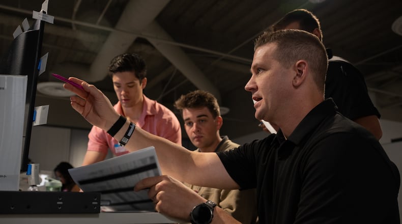 Airmen and industry partners test software during the Air Force’s third Advanced Battle Management System Cross-Functional Team Decision Advantage Sprint for Human-Machine Teaming, or DASH, experiment in Las Vegas, Nevada, Sept. 24, 2025. By demonstrating how human-machine teams can reduce decision time and expand options for battle managers, DASH set the foundation for the Air Force’s next generation of command and control. The Air Force says the paper is blurred in the photo for security reasons. Air Force photo by Airman 1st Class Jennifer Nesbitt.