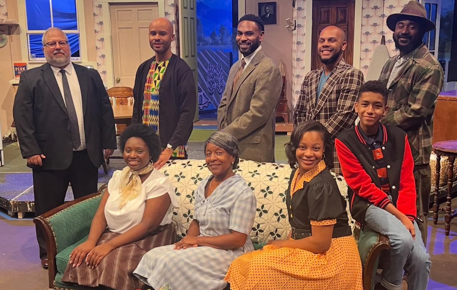 Back row: left to right: Rick Flynn (Karl Lindner), William Boatright Jr. (Joseph Asagai), Shaun Diggs (Walter Lee Younger), Jarrod Davis Jr. (George Murchison), Andre Tomlinson (Bobo); and front row: left to right: Amirah Musa (Beneatha Younger), Gail Andrews Turner (Lena Younger), Cormari Pullings (Ruth Younger) and Dominic Brothers (Travis Younger) in Dayton Theatre Guild's production of "A Raisin in the Sun." Photo courtesy of Dayton Theatre Guild