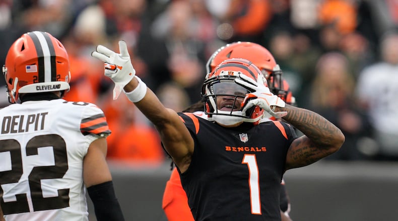 Cincinnati Bengals' Ja'Marr Chase (1) reacts after a first down catch during the second half of an NFL football game against the Cleveland Browns, Sunday, Dec. 11, 2022, in Cincinnati. (AP Photo/Jeff Dean)