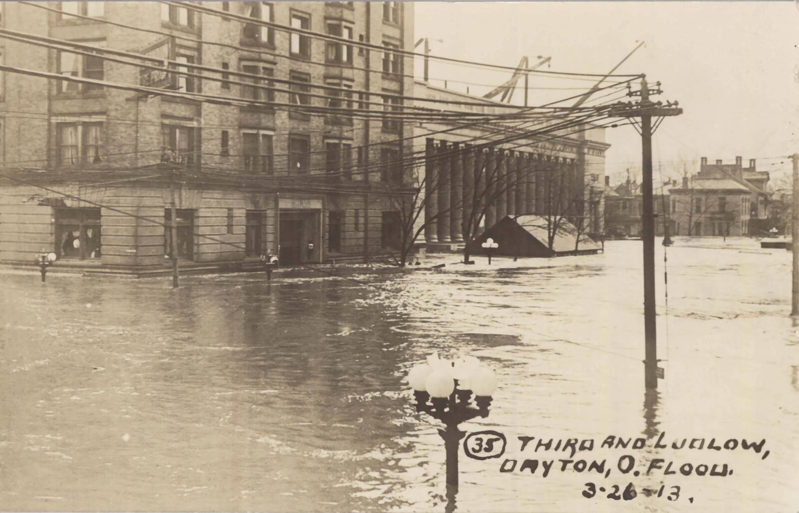 The corner of Third and Ludlow Streets during the Great Flood of 1913 (The Old Post Office Building is pictured partially underwater during construction), March 26, 1913. PHOTO / From the Dayton Metro Library's 1913 Flood Postcards collection