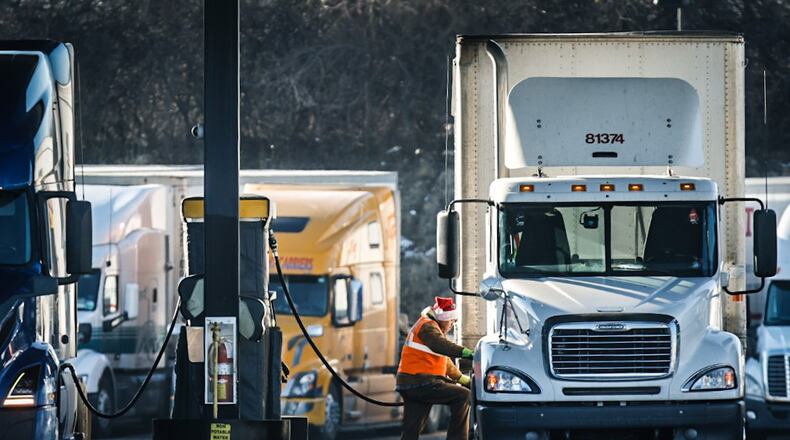 A trucker fills his tanks up with diesel fuel at Love's on South Edwin C. Moses Blvd. Tuesday December 20. 2022. Diesel prices are starting to decline in much the same way all of the nation's 50 states saw gas prices drop precipitously since October. The price of diesel at this Love's was $4.94 a gallon. JIM NOELKER/STAFF