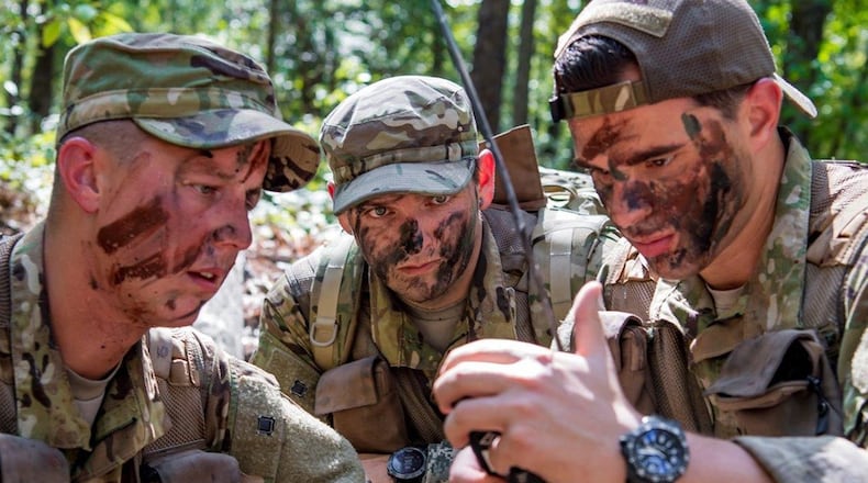 Capt. Logan Hawke, a pilot assigned to the 16th Airlift Squadron Master Sgt. William Davis and Staff Sgt. Randall Moss, loadmasters assigned to the 16th Airlift Squadron, communicate with rescue forces with a radio during a survival, evasion, resistance and escape exercise Aug. 21 in North, S.C. SERE specialists assigned to the 437th Operations Support Squadron conducted this exercise to identify potential areas of improvement in both SERE training and equipment provided to aircrew in case of a potential isolating event. (U.S. Air Force photo/Airman 1st Class Duncan C. Bevan)