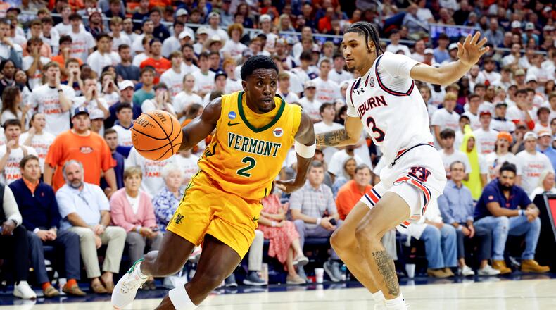 Vermont guard Sam Alamutu (2) drives the baseline around Auburn forward Jahki Howard (3) during the first half of an NCAA college basketball game, Wednesday, Nov. 6, 2024, in Auburn, Ala. (AP Photo/ Butch Dill)