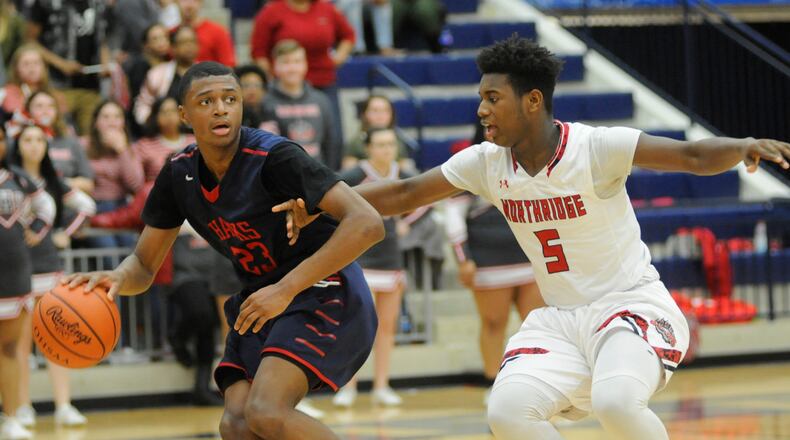 Northridge defender Denny Moses (right) checks Morgan Safford of Hartley. MARC PENDLETON / STAFF