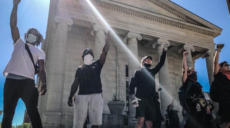 Protesters surround Courthouse Square Sunday May 31, 2020. Later in the day after the curfew was in effect, police patrolled the city enforce. JIM NOELKER/STAFF
