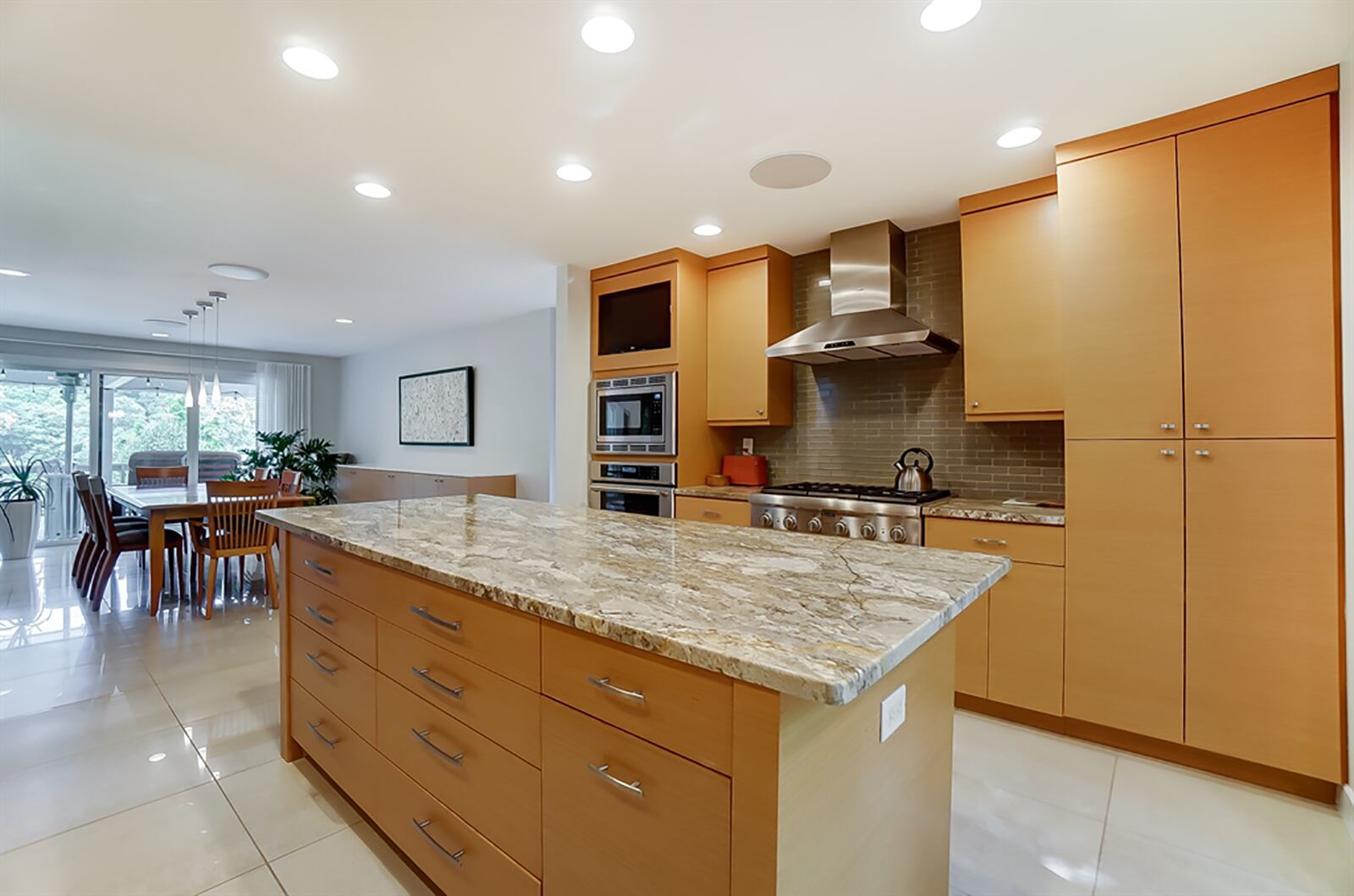 The kitchen has a spacious island, and appliances include a Thermador 6-burner gas range, convection oven, microwave, dishwasher and a Bosch refrigerator. A tall box window fills the kitchen with natural light. A built-in buffet has a granite countertop and storage. CONTRIBUTED PHOTO