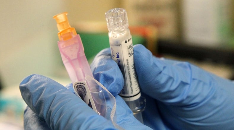 Influenza vaccine being prepared by Montgomery County Public Health Nurse Debbie Parker at their clinic in Dayton. TY GREENLEES / STAFF