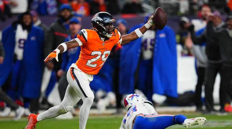 Denver Broncos cornerback Ja'quan McMillian (29) reacts after intercepting a pass intended for Buffalo Bills wide receiver Brandin Cooks (18) during overtime of an NFL divisional round playoff football game, Saturday, Jan. 17, 2026, in Denver. (AP Photo/Jack Dempsey)