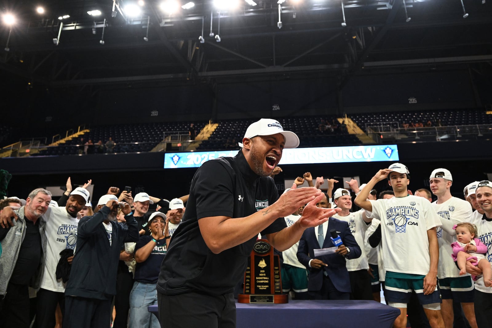 UNC Wilmington head coach Takayo Siddle celebrates after his team defeated Delaware in an NCAA college basketball game in the championship of the Coastal Athletic Association tournament, Tuesday, March 11, 2025, in Washington. (AP Photo/Terrance Williams)
