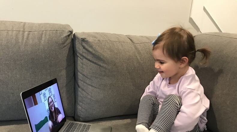 Before the coronavirus pandemic, a normal Tuesday for Sarah Kallile and her daughter Lucy included a trip to storytime at Wright Memorial Public Library in Oakwood. There, Lucy would delight in the music, stories, and playtime led by librarian Karen Mills. Now with the stay-at-home order in place, Mills is in her home, recording a storytime to be broadcast on the library s Facebook page. Kallile is in her own living room, setting up a laptop so 2-year-old Lucy can tune in.