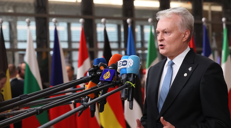 Lithuania's President Gitanas Nauseda speaks with the media as he arrives for an EU Summit at the European Council building in Brussels, Thursday, Oct. 23, 2025. (AP Photo/Francois Walschaerts)