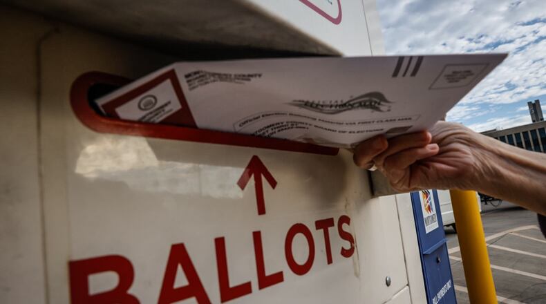 In this file photo from 2023 a Montgomery County voter drops off her ballot in the secure ballot drop box outside the Montgomery County Board of Elections. Jim Noelker/Staff