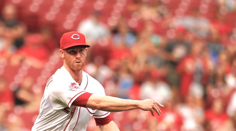 Reds pitcher Anthony DeSclafani throws to first for an out against the Phillies on Tuesday, June 9, 2015, at Great American Ball Park in Cincinnati. David Jablonski/Staff