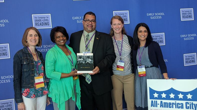 Because of their collaboration on early-childhood education, Montgomery County and the city of Dayton were among 15 communities named All-America Cities by the National Civic League and the Campaign for Grade-Level Reading. From left are Robyn Lightcap, executive director of Learn to Earn Dayton; Geraldine Pegues, Deputy Director of Montgomery County’s Human Services Planning and Development Department; Dayton City Commissioner Chris Shaw; Allison Knight, children’s services librarian for Dayton Metro Library’s outreach services; and Ritika Kurup, director of early learning for Learn to Earn Dayton. CONTRIBUTED PHOTO
