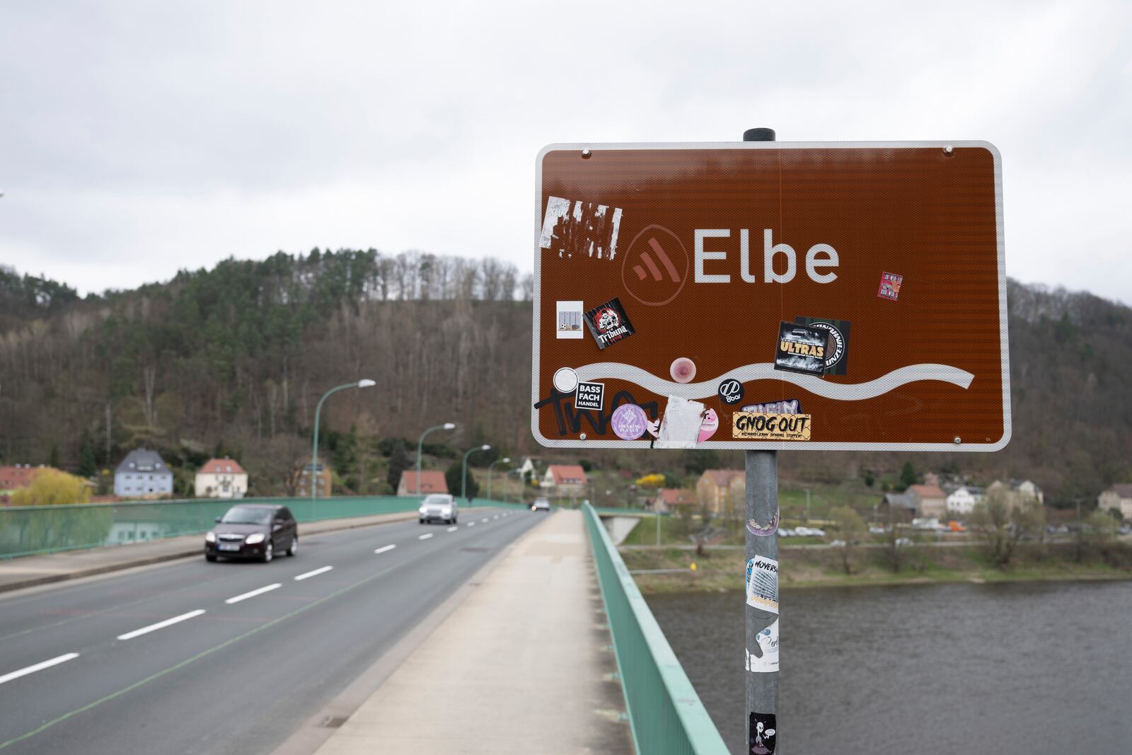 Cars cross the Elbe bridge in Bad Schandau to mark the opening to traffic, in Dresden, Germany, Thursday April 10, 2025. (Sebastian Kahnert/dpa via AP)