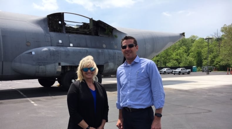 Debbie Naguy, Product Support Engineering Division chief at the Air Force Life Cycle Management Center, and Brian Stitt, division head of Sustainment Technologies Transition at the University of Dayton Research Institute. The C-130 fuselage in the background was delivered to UD Thursday. THOMAS GNAU/STAFF