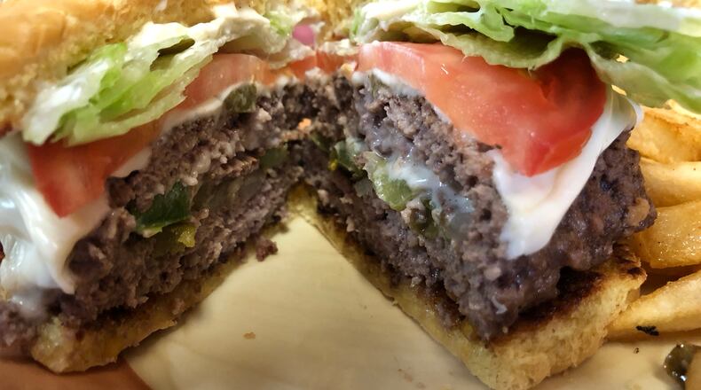Grips Grill and Diner is located at  15 Springfield St. in Dayton. The Big Gripper - stuffed burger with mushrooms, green peppers, onions, bacon and jalapeno peppers  and cheese - is picture with an order of fries.