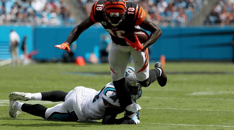 A.J. Green #18 of the Cincinnati Bengals runs the ball against James Bradberry #24 of the Carolina Panthers in the second quarter during their game at Bank of America Stadium on September 23, 2018 in Charlotte, North Carolina. (Photo by Streeter Lecka/Getty Images)