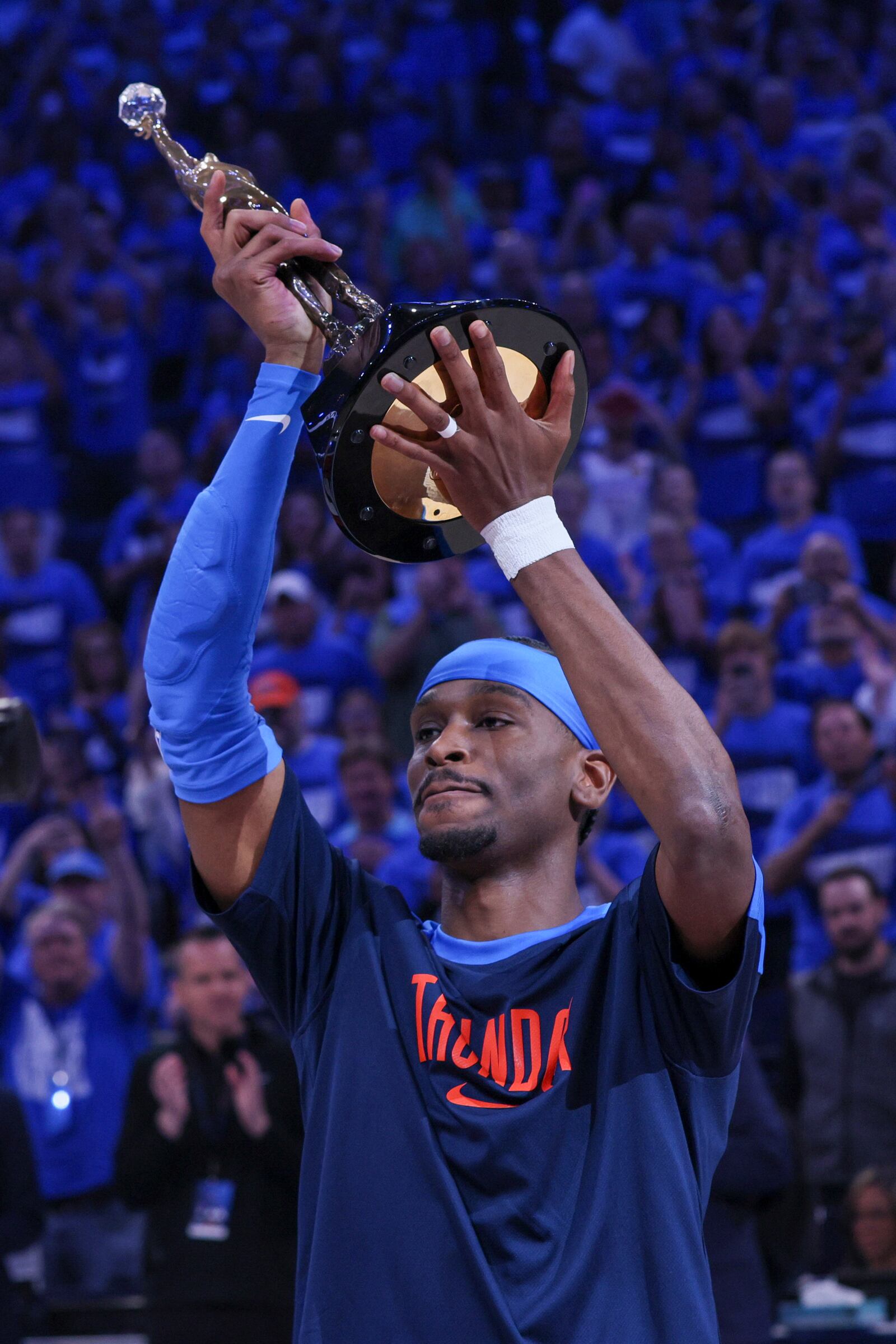 Oklahoma City Thunder guard Shai Gilgeous-Alexander hoists the Michael Jordan Most Valuable Player trophy prior to Game 2 of an NBA basketball Western Conference Finals playoff series between against the Minnesota Timberwolves Thursday, May 22, 2025, in Oklahoma City. (AP Photo/Nate Billings)