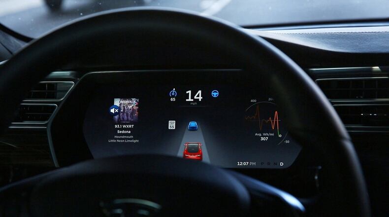 The dashboard of the software-updated Tesla Model S P90D shows the icons enabling Tesla’s autopilot, featuring limited hands-free steering. Car-hacking is a threat that could become serious in the future, when driverless vehicles begin talking to one another. (Chris Walker/Chicago Tribune/TNS)