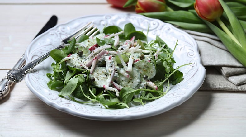 Creme fraiche mixes with fresh chives and dill and lemon juice and zest for a rich dressing to contrast with crisp cucumbers and radishes. (E. Jason Wambsgans/Chicago Tribune/TNS)