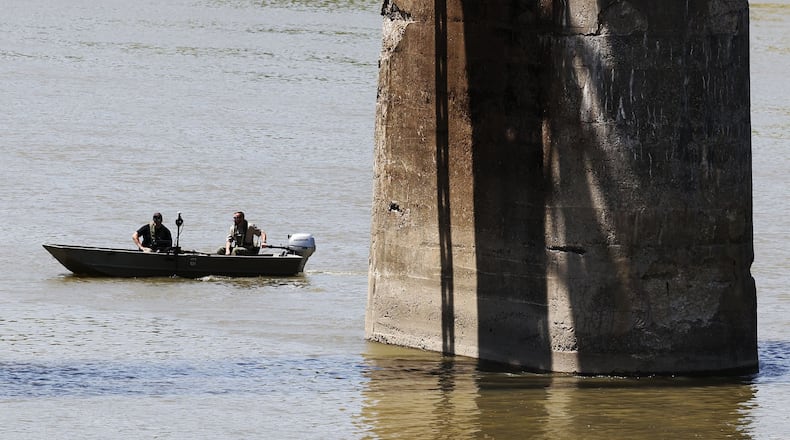 Law enforcement agencies and volunteers search the Great Miami River Tuesday, May 9, 2022 for a person who fled into the river. Butler County Sheriff's Office crews are searching by boat and a group from North Star Seach and Rescue has canines out searching along the river banks. NICK GRAHAM/STAFF