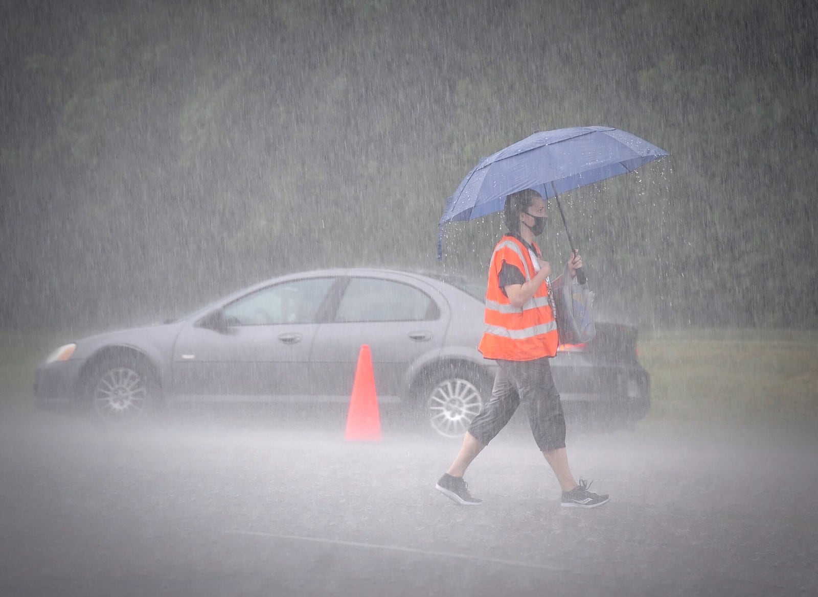 Rains shut down a mass food distribution event at the Nutter Center in Fairborn Thursday. STAFF PHOTO / MARSHALL GORBY