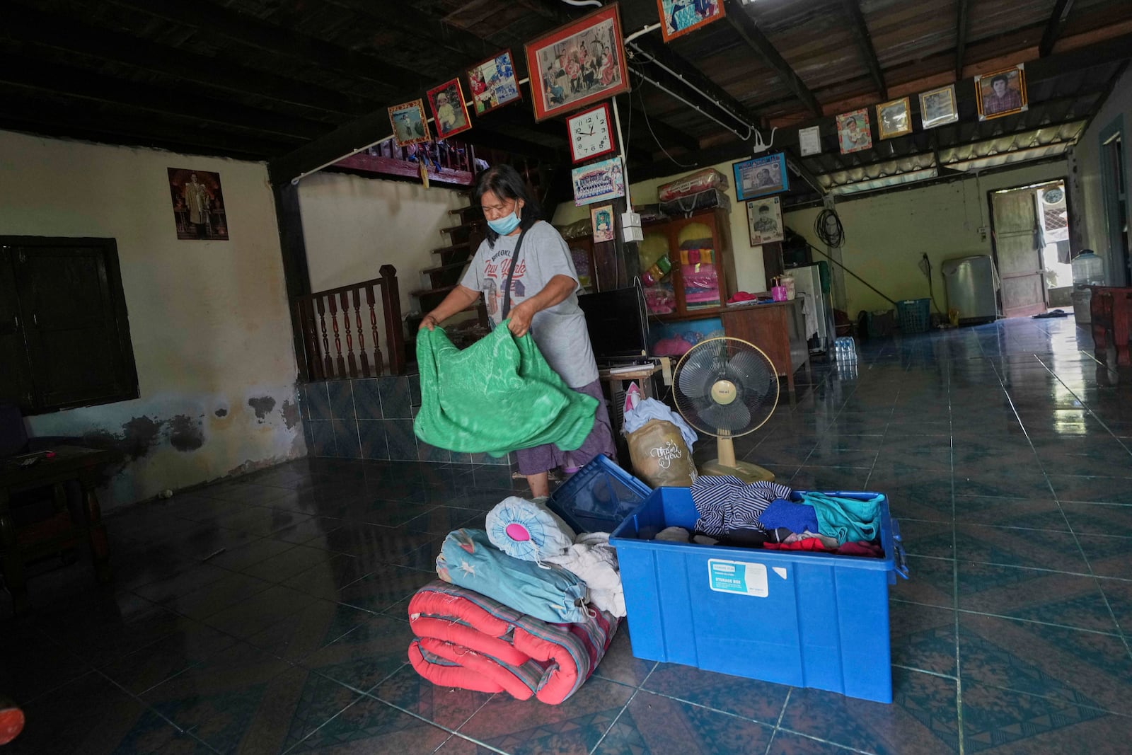 Kalwalin Jindasri who had fled home following the clashes between Thai and Cambodian soldiers, arranges her belongings after returning home in Surin province, Thailand, Tuesday, July 29, 2025 after the ceasefire was supposed to take effect at midnight on July 28, 2025. (AP Photo/Sakchai Lalit)