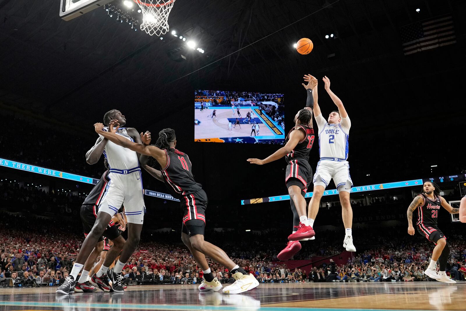 Duke's Cooper Flagg (2) misses a shot as Houston's J'Wan Roberts (13) defends during the second half in the national semifinals at the Final Four of the NCAA college basketball tournament, Saturday, April 5, 2025, in San Antonio. (AP Photo/Eric Gay)