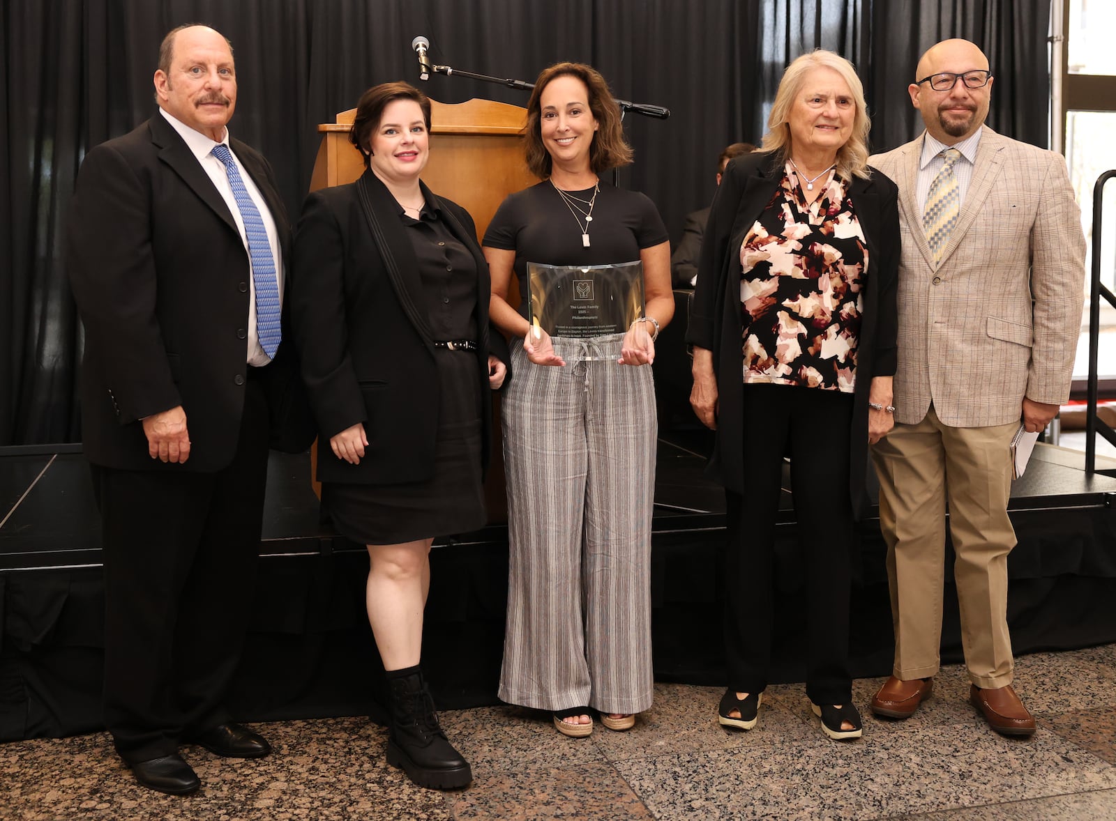 Members of the Levin Family pose during the 2025 Dayton Region Walk of Fame inductee luncheon, which was held Tuesday, Sept. 24 at Sinclair Community College. The Levin Family was inducted along with the Original Lakeside, Rob Lowe, Jenell Ross and Vic Cassano Sr. BRYANT BILLING / STAFF