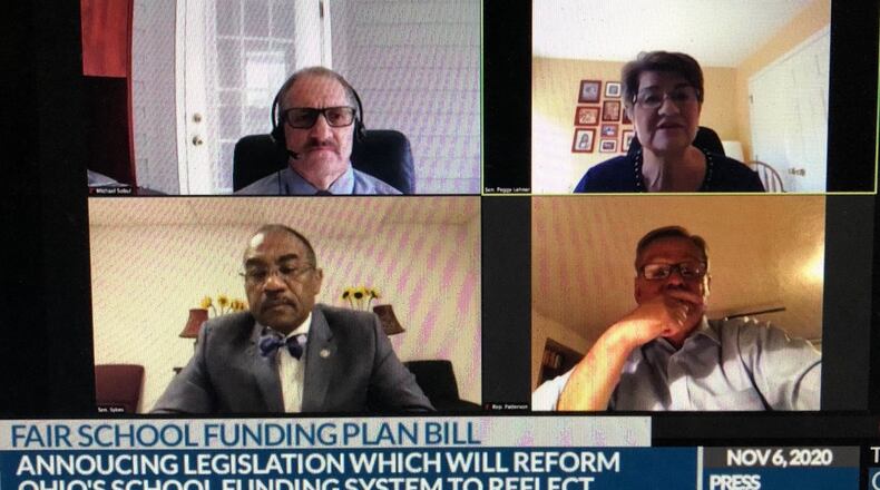 Clockwise from top right, State Sen. Peggy Lehner, State Rep. John Patterson, State Sen. Vernon Sykes and analytics consultant Mike Sobul discuss a bill Friday, Nov. 6 that would change Ohio's school funding model. JEREMY P. KELLEY / STAFF