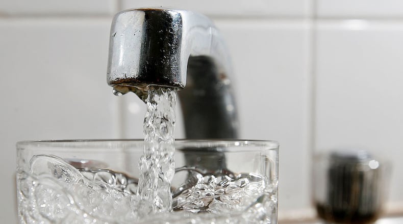 A glass of water is filled at a kitchen tap. (File Photo by Cate Gillon/Getty Images)