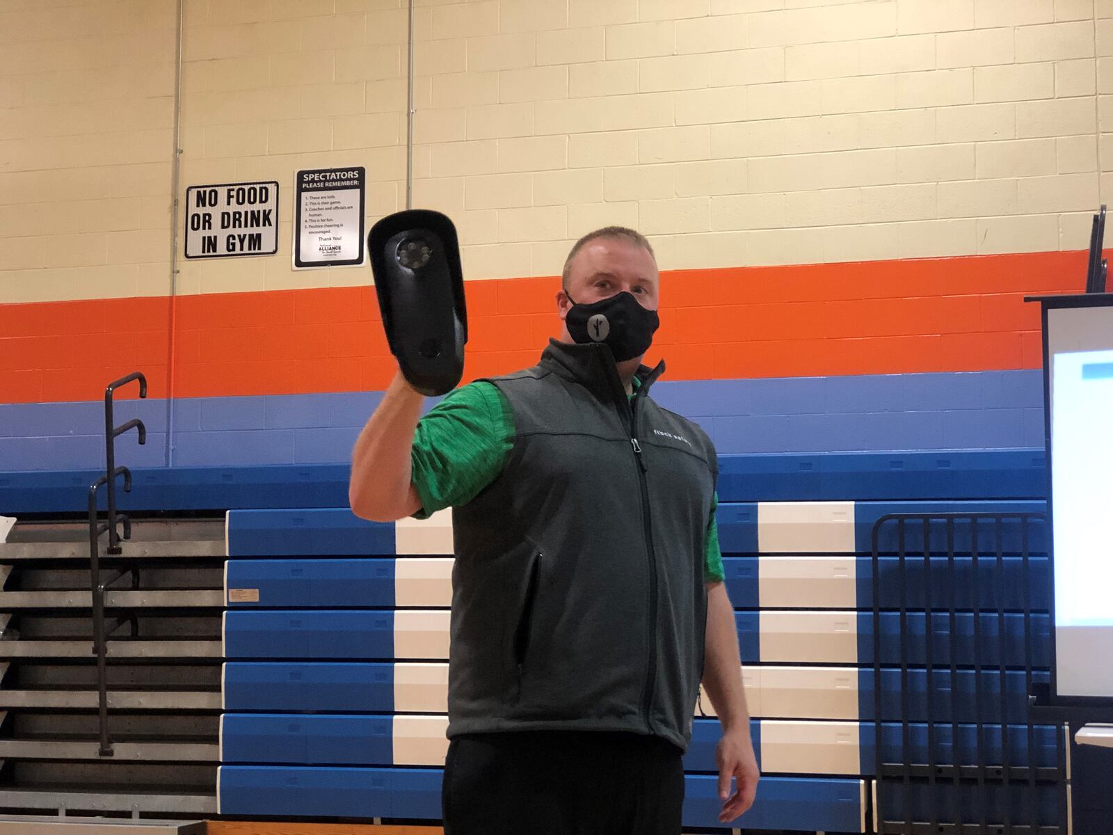 Flock Safety Territory Manager Rick Lombardo holds an automated license plate reader at a recent community meeting. The Dayton Police Department says it is considering deploying the devices in neighborhoods that want them. CORNELIUS FROLIK / STAFF