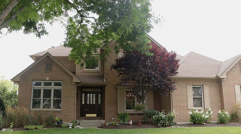 The brick 2-story has picturesque views of rolling hills of the golf course and nearby countryside. The home has about 4,600 sq. ft. of living space, including a finished basement. Located within the Heatherwoode Golf Club community, the house sits on a tailored landscaped property along the ninth tee and has is a 3-car, side-entry garage. CONTRIBUTED PHOTO BY KATHY TYLER