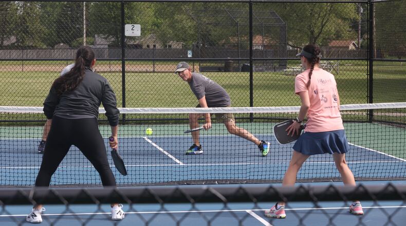 Jake Burns, center, of Springfield, plays pickleball at J.F. Kennedy Park on May 8, 2025, in Kettering. David Jablonski/Staff