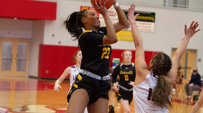 Centerville's Cotie McMahon scores over Lebanon's Kendall Folley during the first half of Saturday's Division I district final at Princeton High School. Jeff Gilbert/CONTRIBUTED