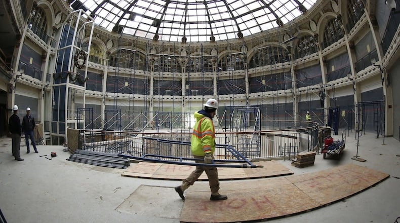 Scaffolding is being installed to complete lead paint removal inside the Dayton Arcade rotunda area. The escalator has been removed and is elevator is to be removed soon according to developers. TY GREENLEES / STAFF