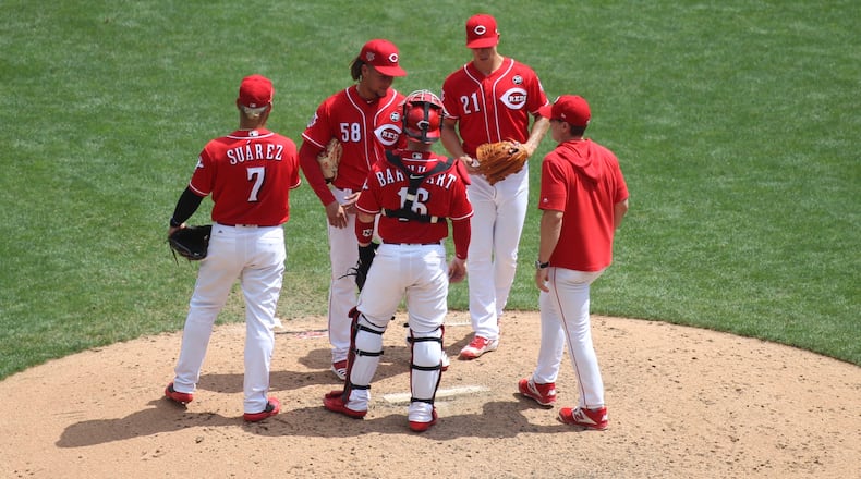 Reds manager David Bell visits the mound during a game against the Pirates on July 31, 2019, at Great American Ball Park in Cincinnati. David Jablonski/Staff