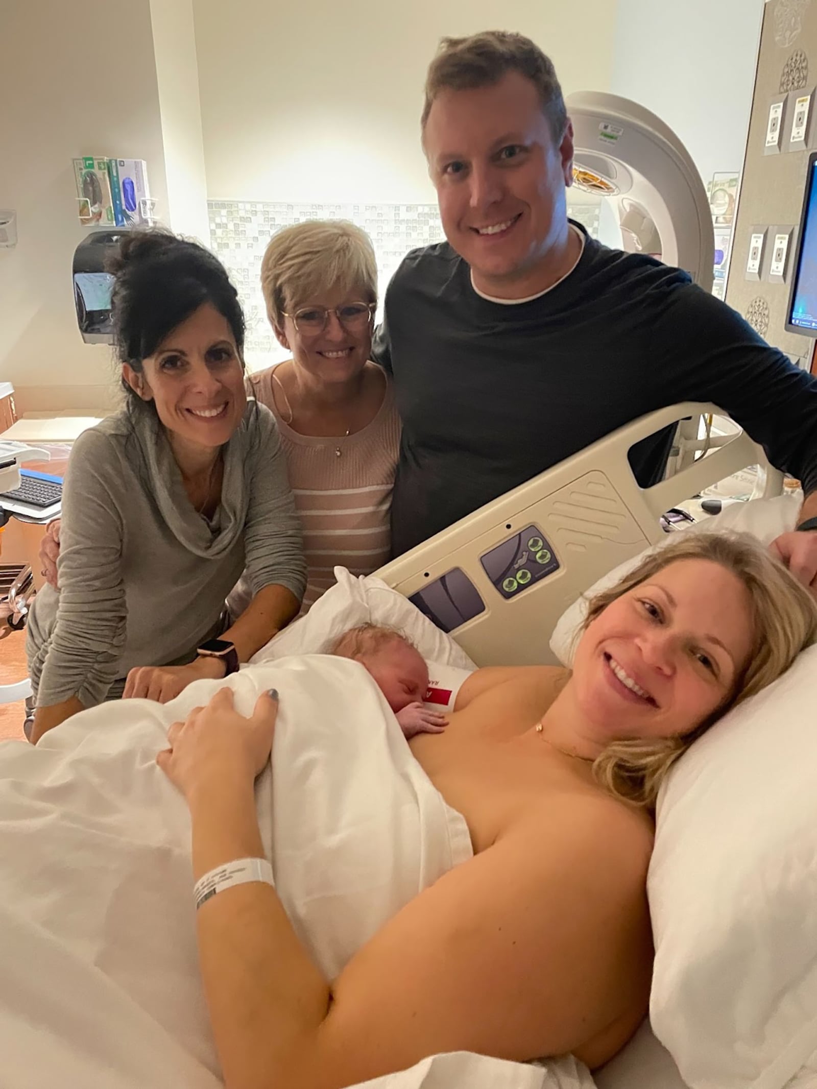 Erica Paulson (Left) is a certified Doula and helps women before, during and after their pregnancies. She is shown in 2025 with (Left to Right) grandmother Lisa Sprong, father Nick Borgmann and mother (with baby) Lindsey Borgmann shortly after the baby's birth. CONTRIBUTED