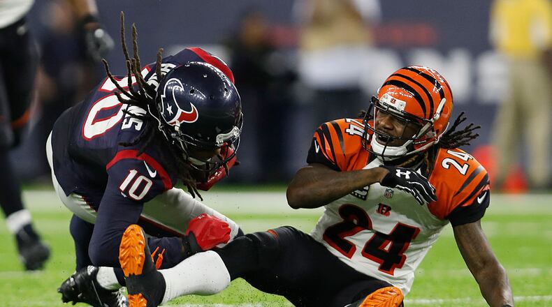 HOUSTON, TX - DECEMBER 24: Adam Jones #24 of the Cincinnati Bengals tackles DeAndre Hopkins #10 of the Houston Texans in the fourth quarter at NRG Stadium on December 24, 2016 in Houston, Texas. (Photo by Tim Warner/Getty Images)