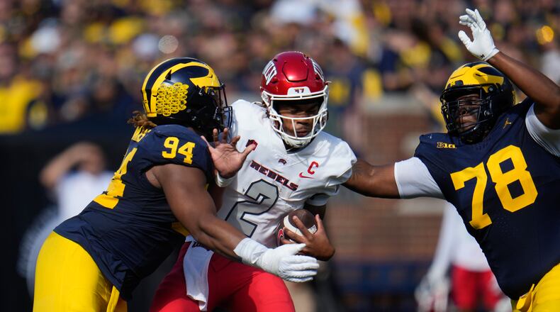 UNLV quarterback Doug Brumfield (2) is sacked by Michigan defensive linemen Kris Jenkins (94) and Kenneth Grant (78) in the first half of an NCAA college football game in Ann Arbor, Mich., Saturday, Sept. 9, 2023. (AP Photo/Paul Sancya)
