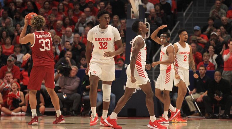 Dayton players react after a defensive stop against Massachusetts on Saturday, Jan. 11, 2020, at UD Arena. David Jablonski/Staff