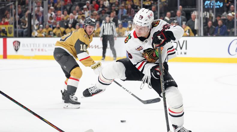Chicago Blackhawks center Connor Bedard (98) passes the puck against the Vegas Golden Knights during the first period of an NHL hockey game Tuesday, Dec. 2, 2025, in Las Vegas. (AP Photo/Ian Maule)