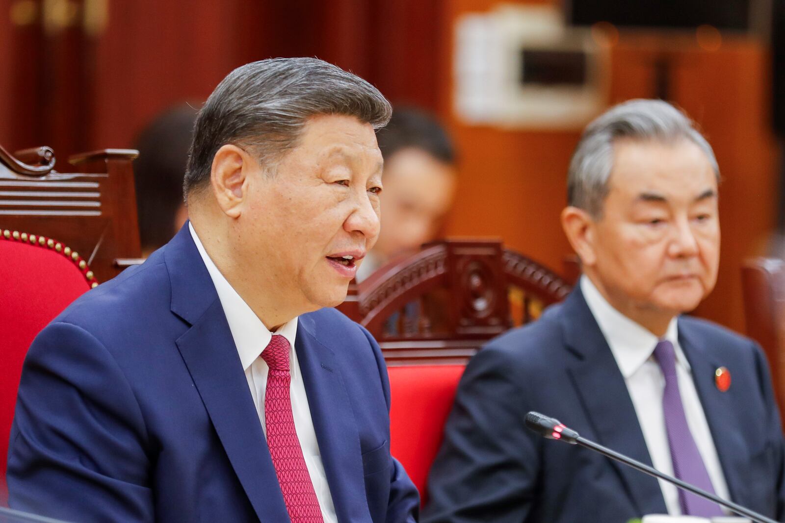Chinese President Xi Jinping, left, speaks to Vietnamese Prime Minister Pham Minh Chinh, not pictured, during their meeting at the Office of the Party Central Committee in Hanoi, Vietnam, Monday, April 14, 2025. (AP Photo/Minh Hoang, Pool)