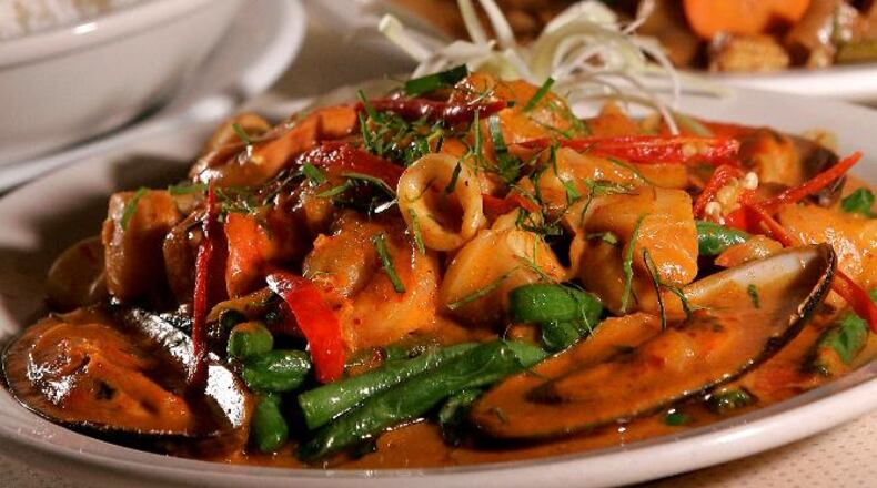 Panang curry with seafood (foreground) and spicy fried noodles with vegetables (back) at Thai 9 located in Dayton's Oregon District. Staff photo by Lisa Powell