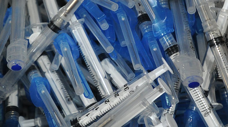 Members of  the Dayton & Montgomery County Public Health, prepare for the COVID-19 vaccination clinic Wednesday, April 28, 2021 at the Sinclair College Centerville, located at 5800 Clyo Rd. MARSHALL GORBY\STAFF