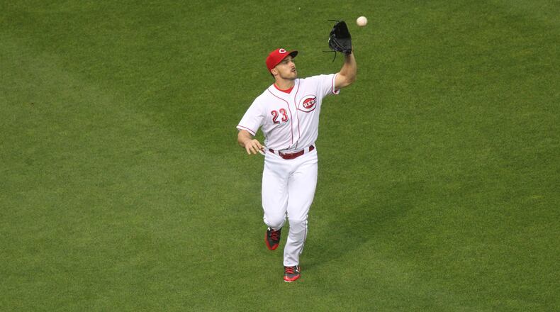 Reds left fielder Adam Duvall makes a catch against the Rockies on Friday, May 19, 2017, at Great American Ball Park in Cincinnati. David Jablonski/Staff