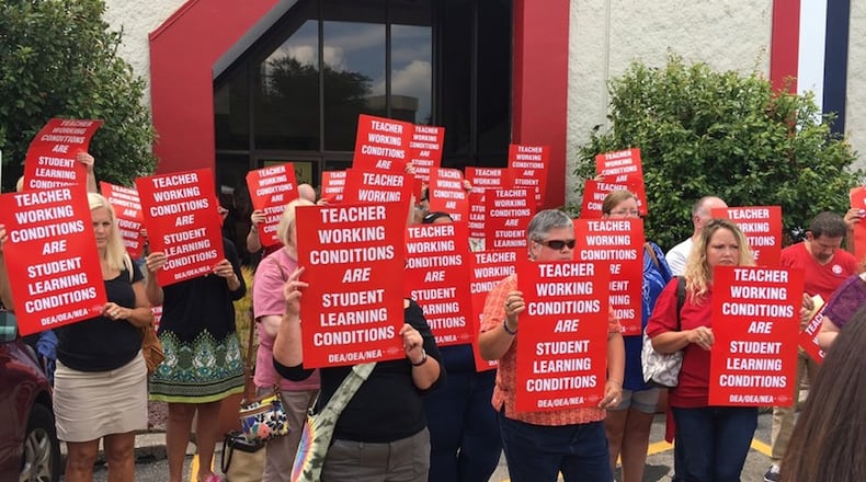Dayton Education Association members Tuesday protested the lack of a new contract with Dayton Public Schools. Teachers have authorized a strike if a deal is not reached by Aug. 11. JEREMY P. KELLEY / STAFF