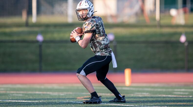 Waynesville High School junior quarterback Alex Amburgy drops back to pass during their game on Thursday night against Oakwood at Spartan Community Stadium. Waynesville won 45-14. CONTRIBUTED PHOTO BY MICHAEL COOPER